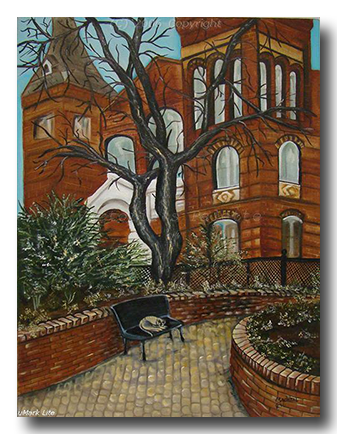 Home Décor brick court house behind a barren oak tree cobble stone walkway with cat on metal bench